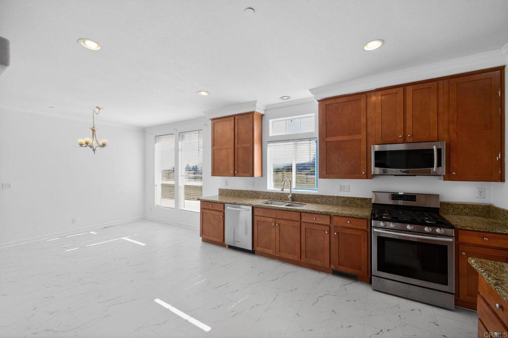 37455 Brandon Road Anza, CA 92539 - Photo 12 of 26 a large kitchen with stainless steel appliances a stove a sink dishwasher and a microwave oven on the blue kitchen countertops