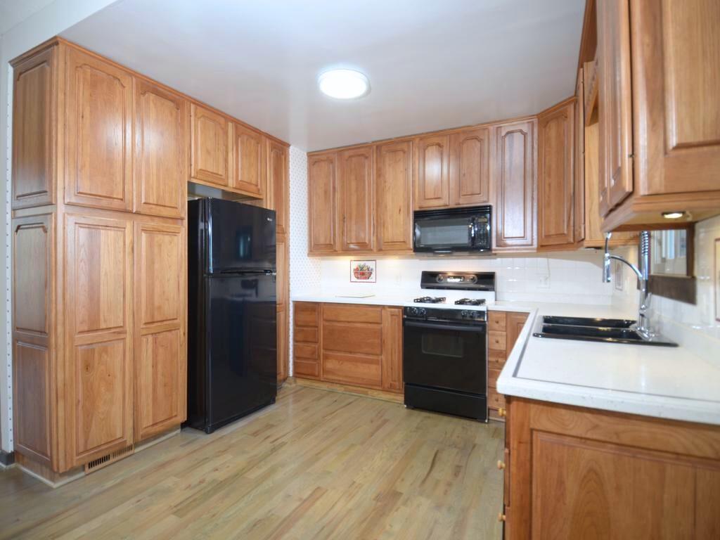1179 Justice Drive Kennesaw, GA 30152 - Photo 11 of 30 a kitchen with granite countertop wooden cabinets and a stove top oven