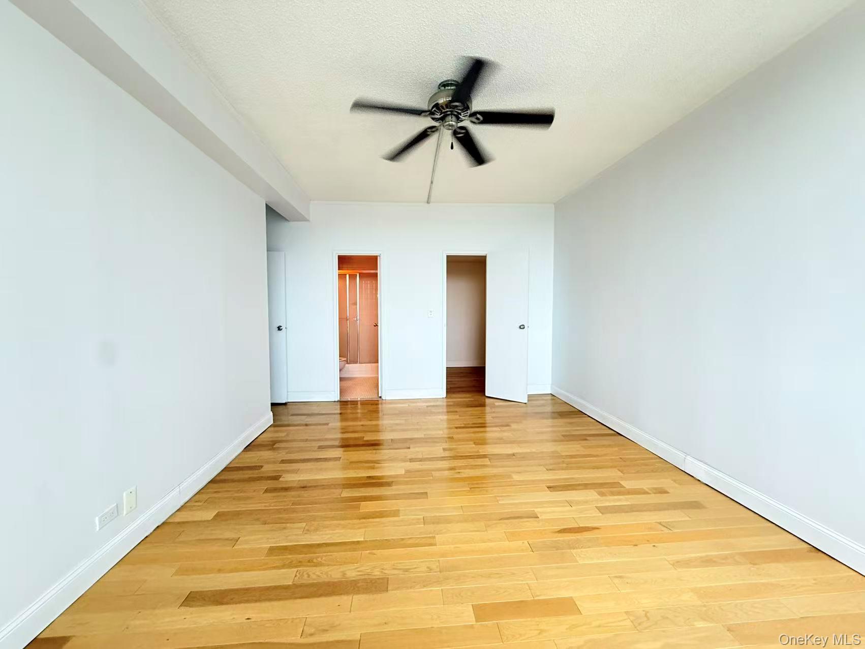 2 Bay Club Drive, Unit PHJ Queens, NY 11360 - Photo 11 of 17 a view of empty room with wooden floor