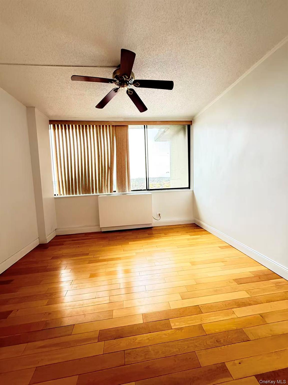 2 Bay Club Drive, Unit PHJ Queens, NY 11360 - Photo 14 of 17 a view of empty room with wooden floor and fan