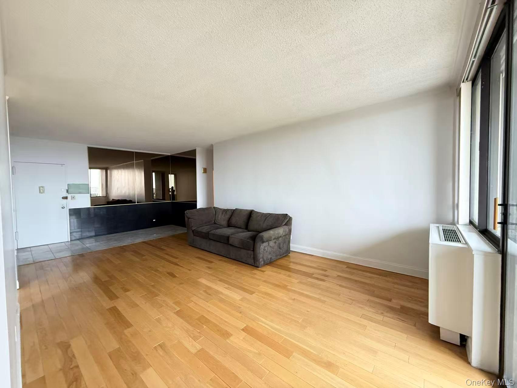 2 Bay Club Drive, Unit PHJ Queens, NY 11360 - Photo 3 of 17 a living room with furniture and a flat screen tv