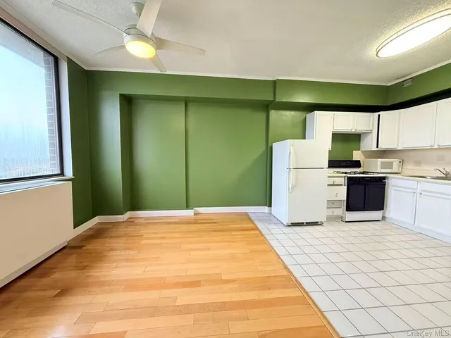 a kitchen with a refrigerator and window