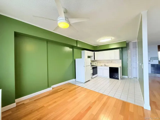 a view of a kitchen with microwave and cabinets