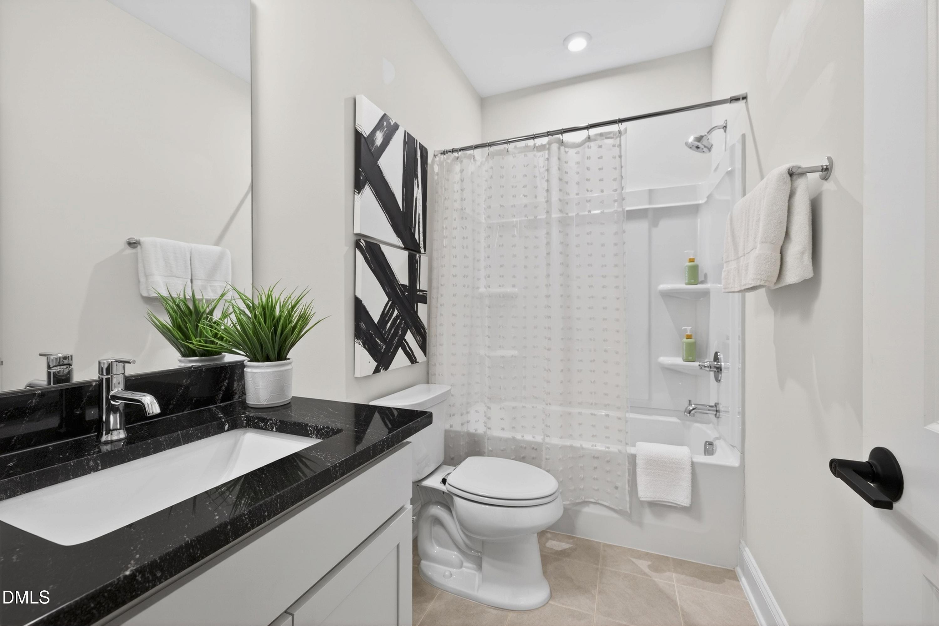 1063 Danvers Loop Apex, NC 27523 - Photo 59 of 67 a bathroom with a sink a toilet and a shower