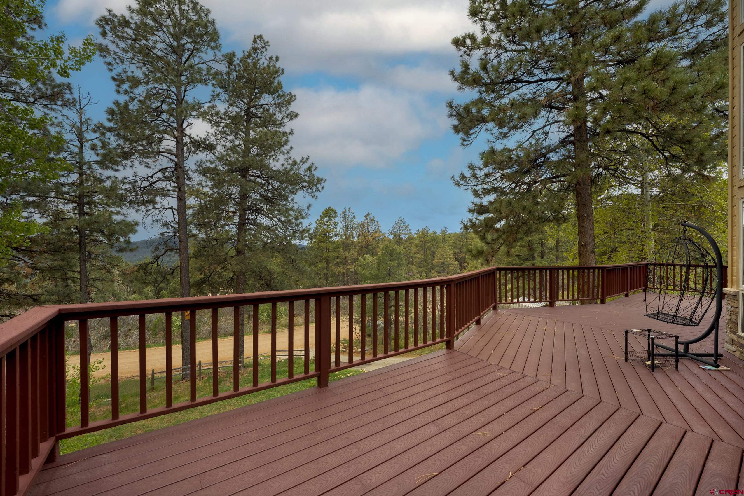 197 Buckhorn Road Bayfield, CO 81122 - Photo 2 of 34 a balcony with wooden floor and outdoor seating