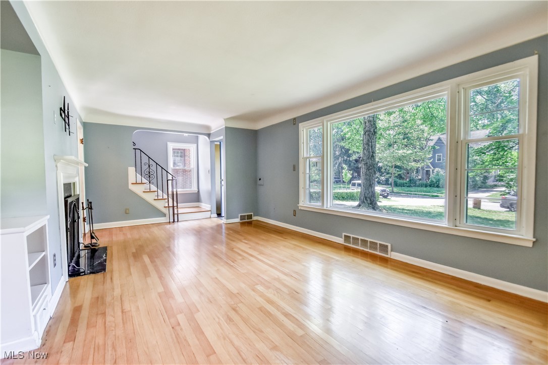 2607 Ashurst Road University Heights, OH 44118 - Photo 14 of 39 Unfurnished living room with light wood-type flooring and stairway