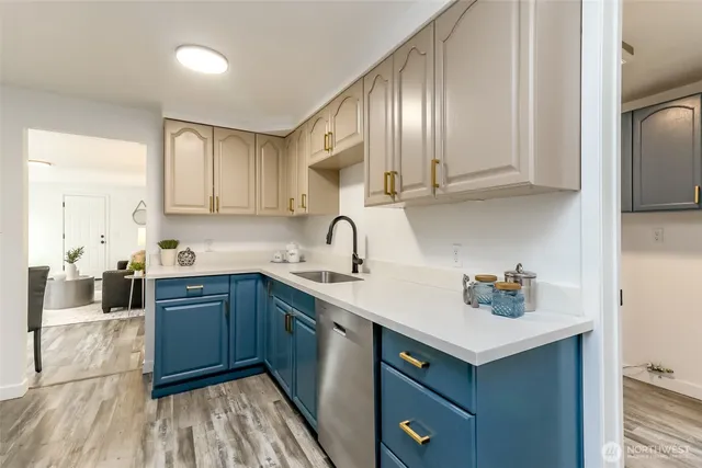 a kitchen with granite countertop a stove microwave and sink