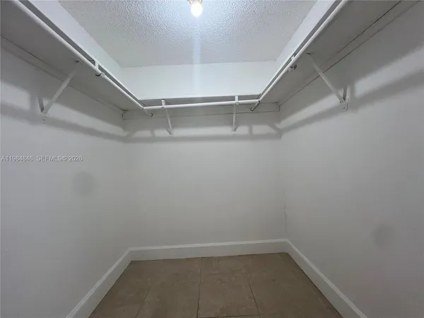 a bathroom with a white toilet and a shower