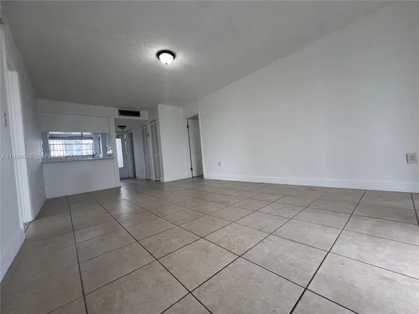 a view of an empty room and entryway