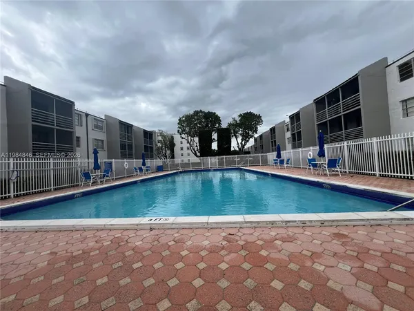 a swimming pool with outdoor seating and yard