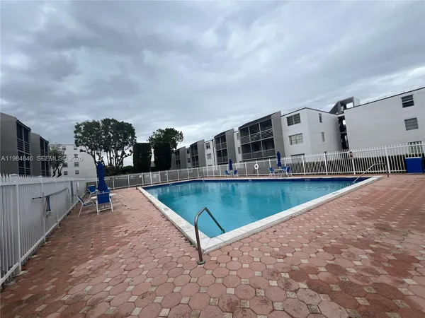 a view of swimming pool with outdoor seating and yard