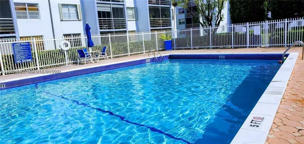 a view of swimming pool with a bench
