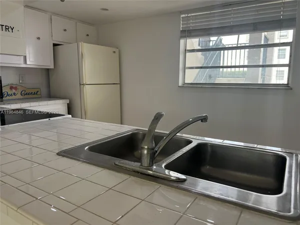 a kitchen with a sink and a refrigerator