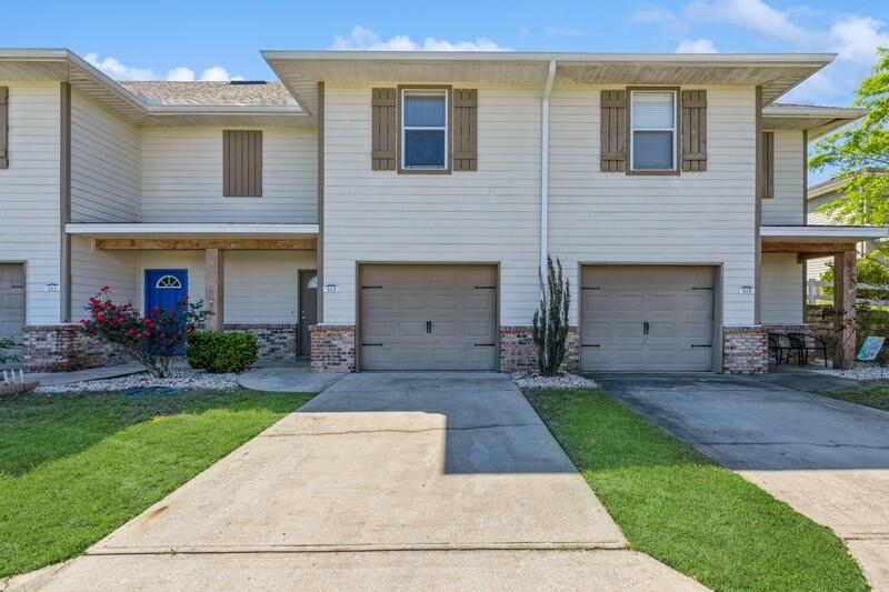 513 Arbor Lake Drive, Unit 513 Crestview, FL 32536 - Photo 1 of 37 a front view of a house with a yard and garage