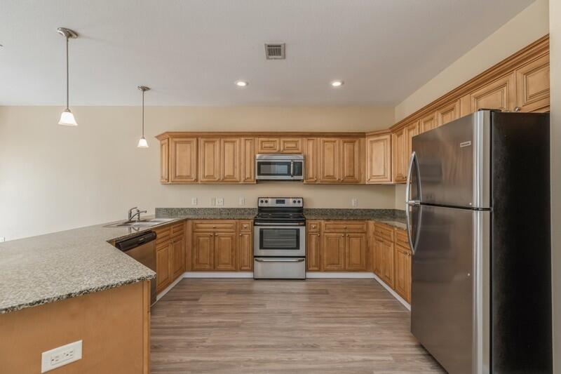 513 Arbor Lake Drive, Unit 513 Crestview, FL 32536 - Photo 11 of 37 a kitchen with granite countertop a refrigerator and a sink