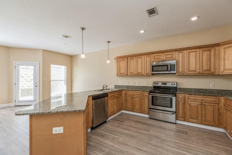513 Arbor Lake Drive, Unit 513 Crestview, FL 32536 - Photo 12 of 37 a kitchen with stainless steel appliances granite countertop a stove top oven a sink dishwasher window and cabinets
