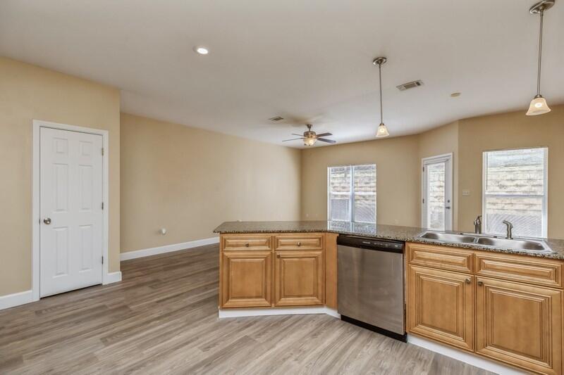 513 Arbor Lake Drive, Unit 513 Crestview, FL 32536 - Photo 13 of 37 a kitchen with granite countertop a sink cabinets and wooden floor