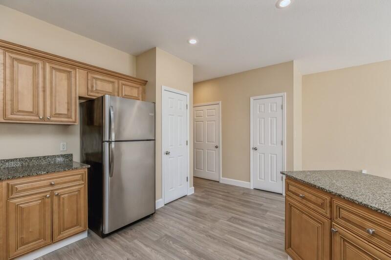 513 Arbor Lake Drive, Unit 513 Crestview, FL 32536 - Photo 14 of 37 a kitchen with a refrigerator cabinet and a granite counter top