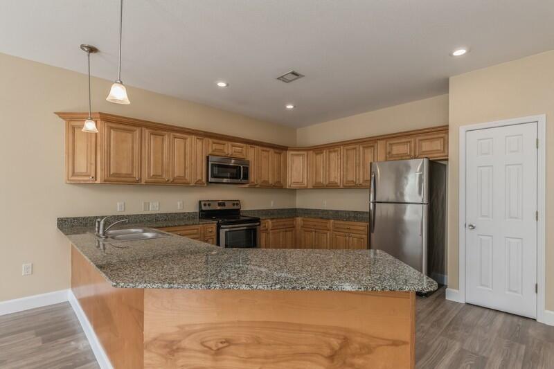 513 Arbor Lake Drive, Unit 513 Crestview, FL 32536 - Photo 15 of 37 a kitchen with stainless steel appliances granite countertop a sink refrigerator and microwave