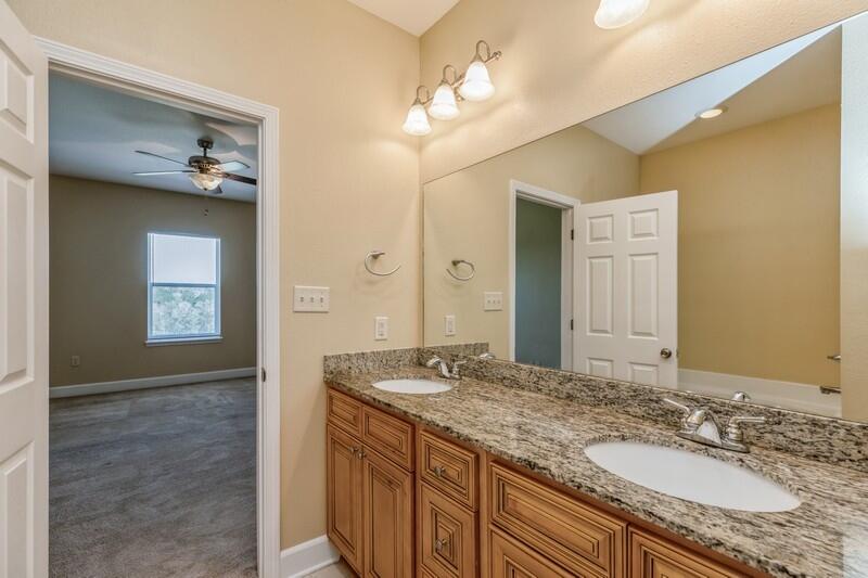 513 Arbor Lake Drive, Unit 513 Crestview, FL 32536 - Photo 23 of 37 a bathroom with a granite countertop sink and a mirror