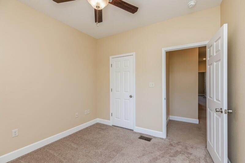 513 Arbor Lake Drive, Unit 513 Crestview, FL 32536 - Photo 28 of 37 an empty room with a ceiling fan and carpet