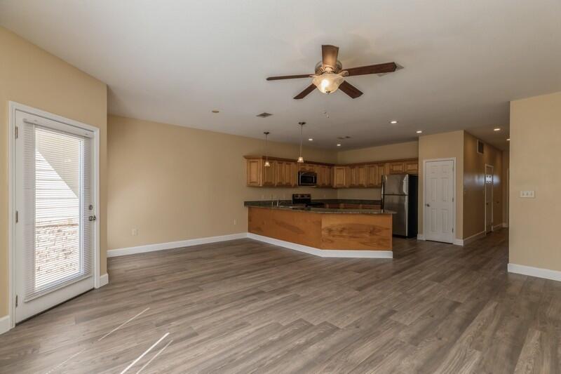 513 Arbor Lake Drive, Unit 513 Crestview, FL 32536 - Photo 6 of 37 a view of empty room with wooden floor and window
