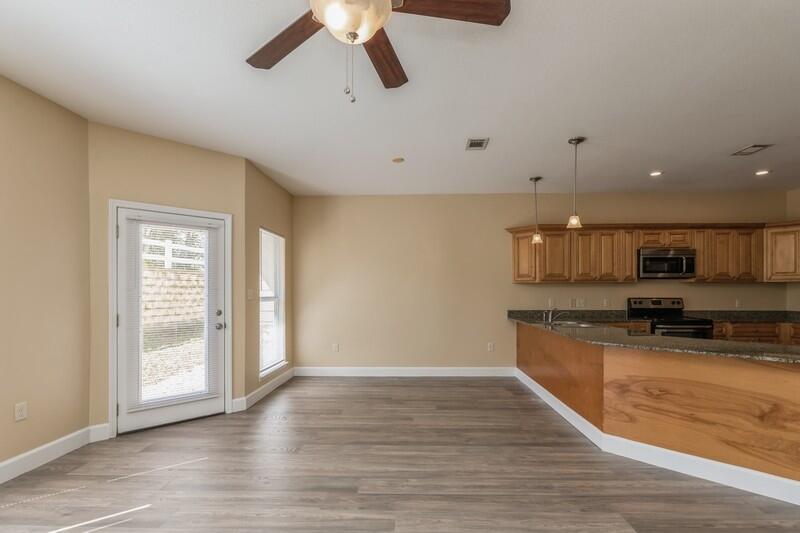 513 Arbor Lake Drive, Unit 513 Crestview, FL 32536 - Photo 7 of 37 a large kitchen with stainless steel appliances granite countertop a stove a sink and a microwave