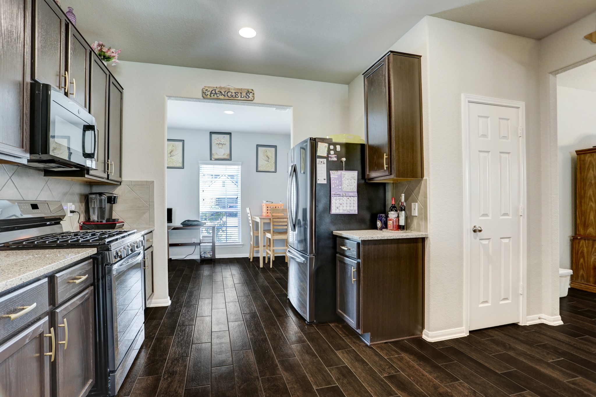 5414 Rustic Ruby Drive Fulshear, TX 77423 - Photo 4 of 26 The wood like tile floors extend into throughout all lower level loving spaces.