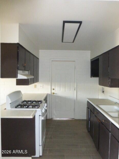 401 Greenwich Road Kearny, AZ 85137 - Photo 13 of 25 a kitchen with stainless steel appliances a sink a stove and a refrigerator