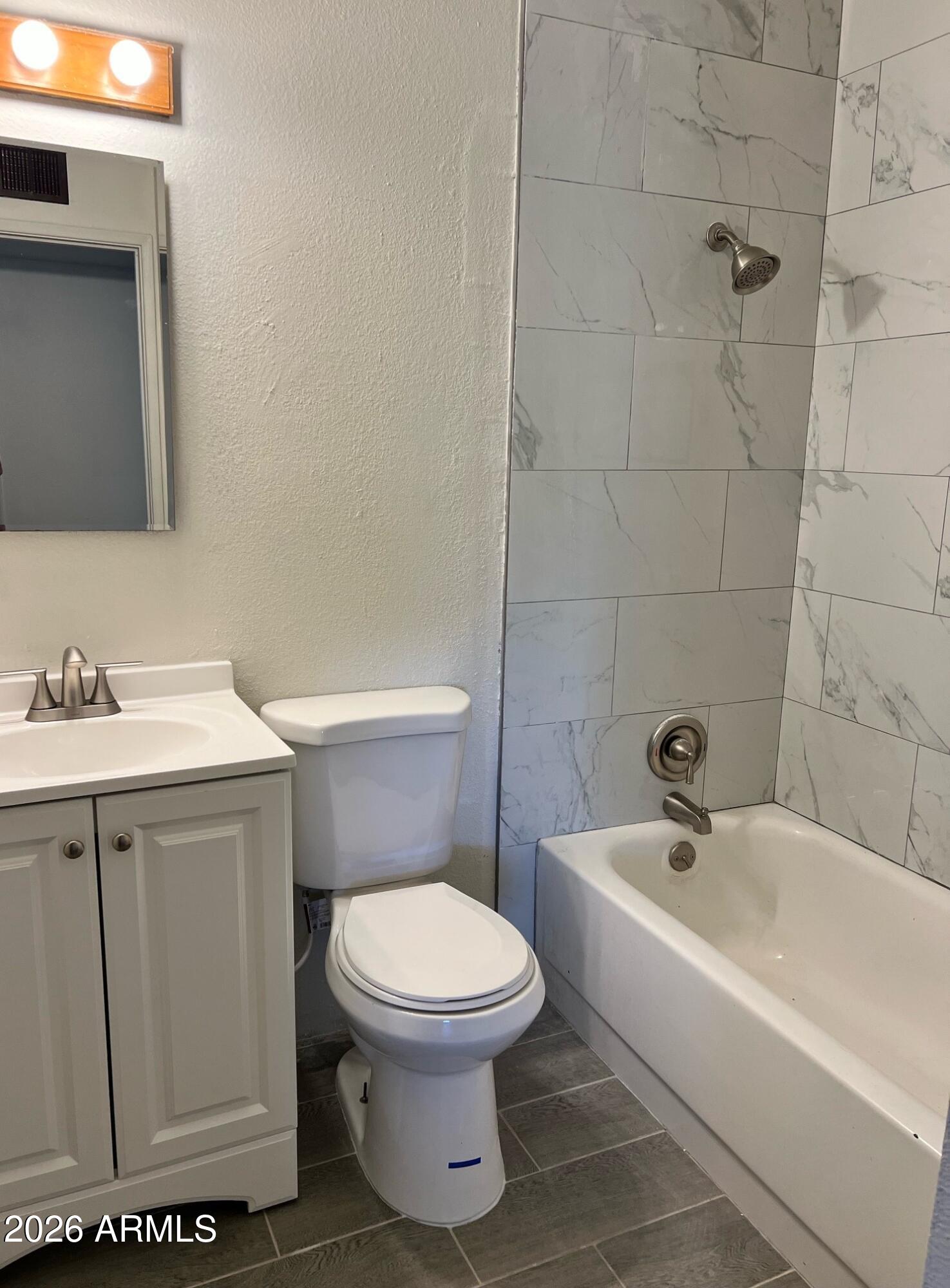 401 Greenwich Road Kearny, AZ 85137 - Photo 23 of 25 a white toilet sitting next to a bathroom sink