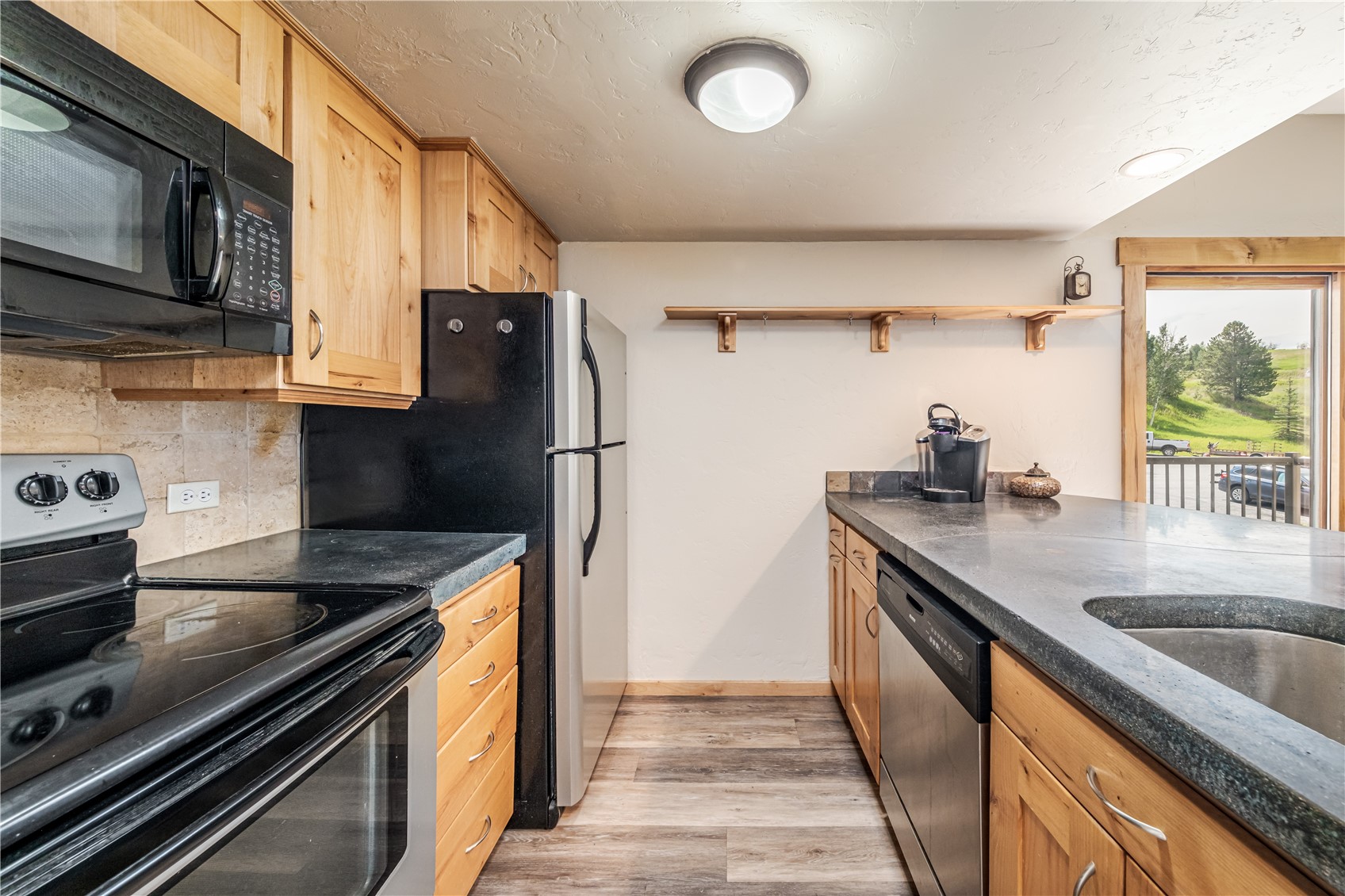 1945 Cornice Road, Unit 2221 Steamboat Springs, CO 80487 - Photo 11 of 24 a kitchen with stainless steel appliances granite countertop a sink stove and refrigerator