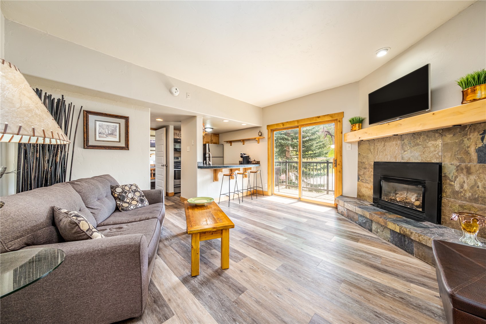 1945 Cornice Road, Unit 2221 Steamboat Springs, CO 80487 - Photo 2 of 24 a living room with fireplace furniture and a flat screen tv
