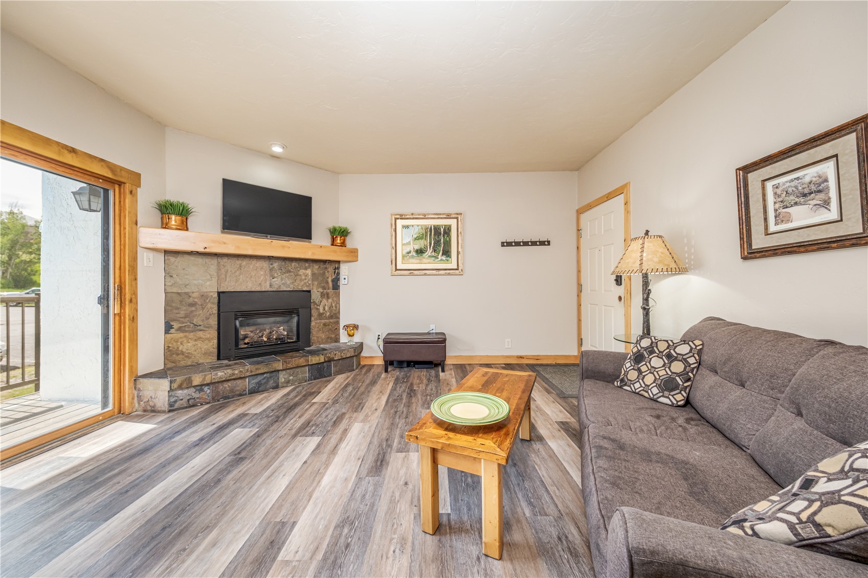 1945 Cornice Road, Unit 2221 Steamboat Springs, CO 80487 - Photo 3 of 24 a living room with furniture a flat screen tv and a fireplace