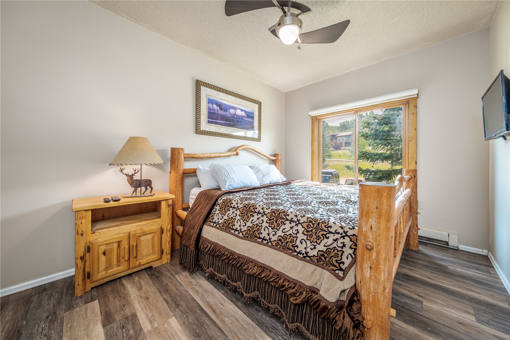 1945 Cornice Road, Unit 2221 Steamboat Springs, CO 80487 - Photo 8 of 24 a bed sitting in a bedroom next to a window