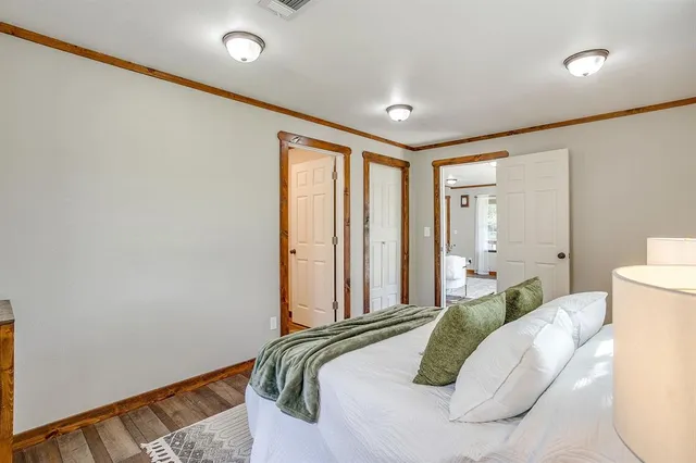 a bedroom with a bed and a large window