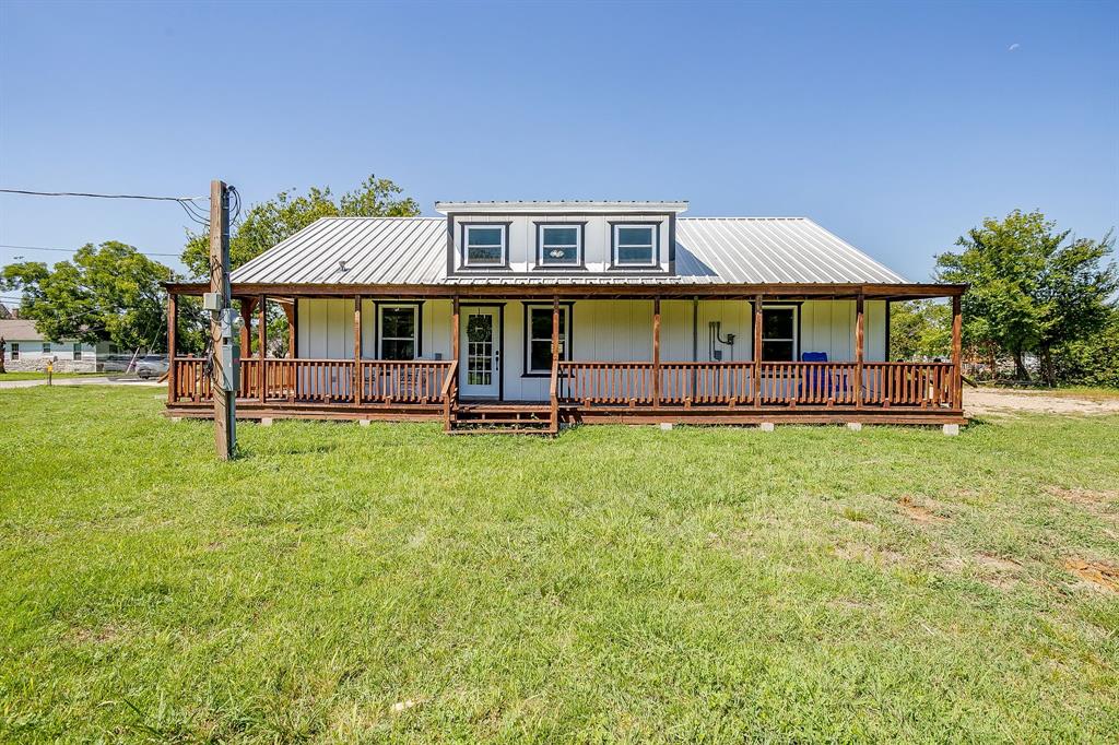 607 East Main Street Itasca, TX 76055 - Photo 2 of 40 a front view of a house with a yard table and chairs