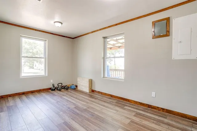 a view of wooden floor and windows in a room