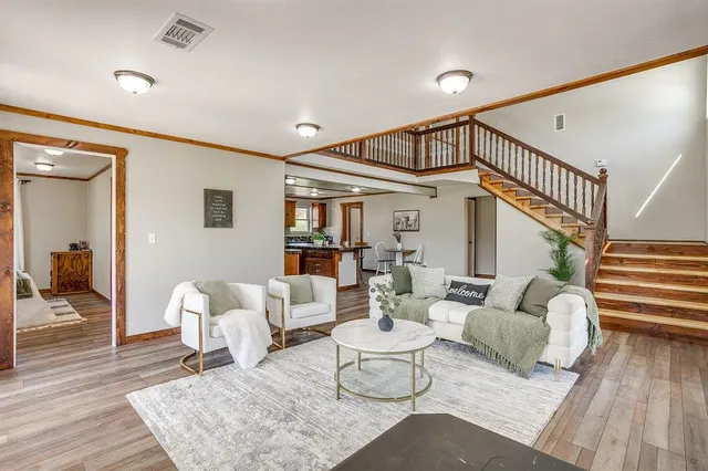 a living room with furniture and wooden floor