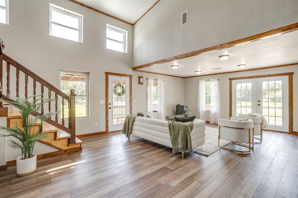 607 East Main Street Itasca, TX 76055 - Photo 5 of 40 a living room with furniture floor to ceiling window and wooden floor