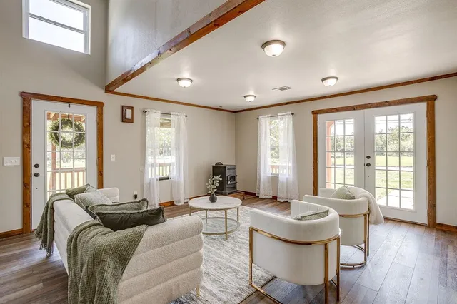 a living room with furniture and large windows