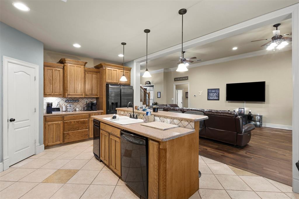 105 Country Ridge Court Red Oak, TX 75154 - Photo 13 of 40 a kitchen with stainless steel appliances granite countertop a sink and a stove
