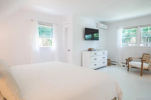 a room with a bed and a flat screen tv