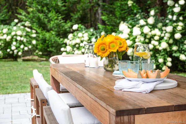 a view of a patio with table and chairs