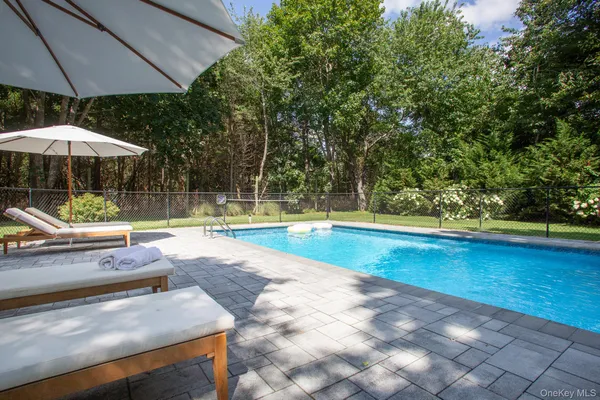 a view of a backyard with swimming pool