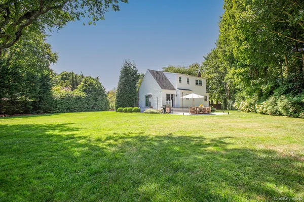 a house view with swimming pool in front of it