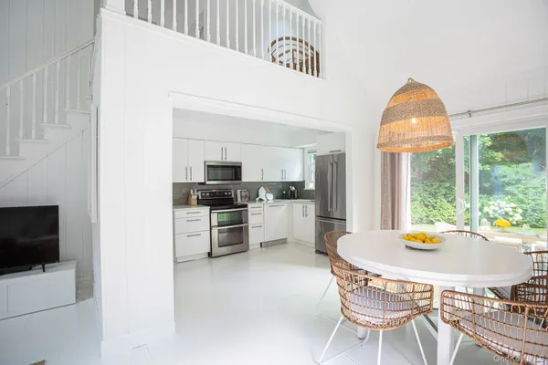 a kitchen with a stove a refrigerator and a fireplace