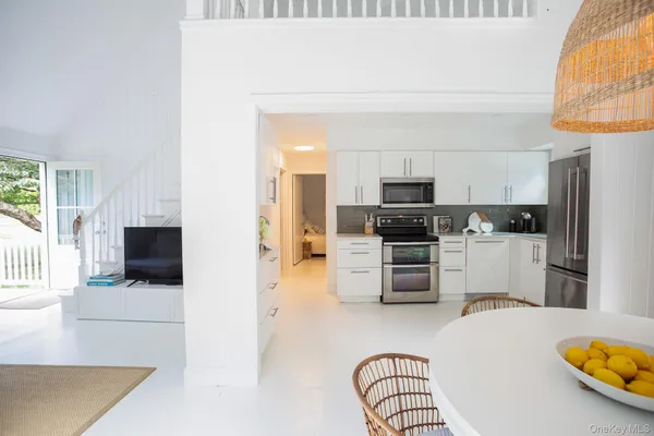 a kitchen with stainless steel appliances a stove a microwave and a refrigerator
