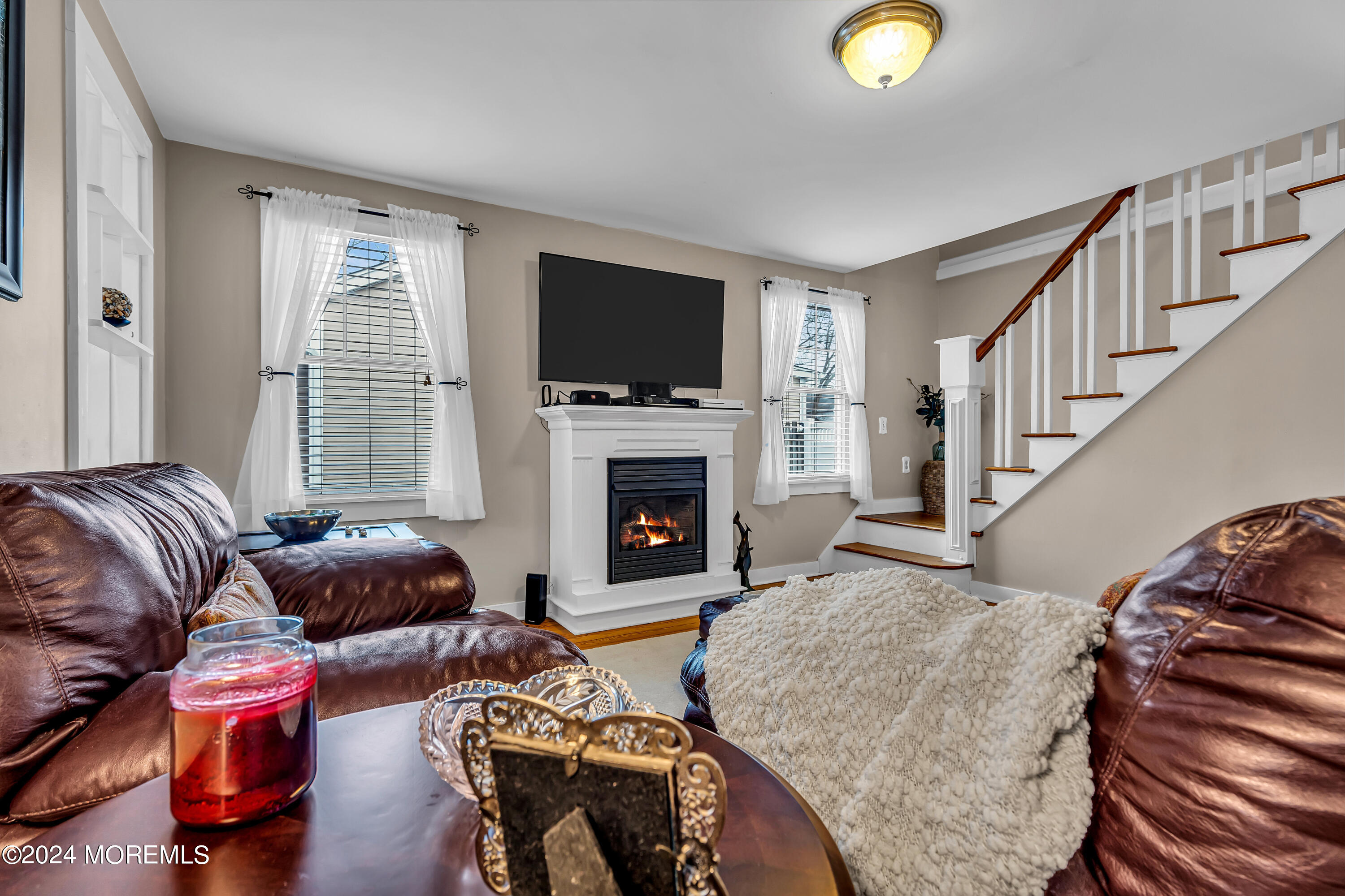 2412 Dunkle Road Point Pleasant, NJ 08742 - Photo 11 of 51 a living room with furniture a flat screen tv and a fireplace