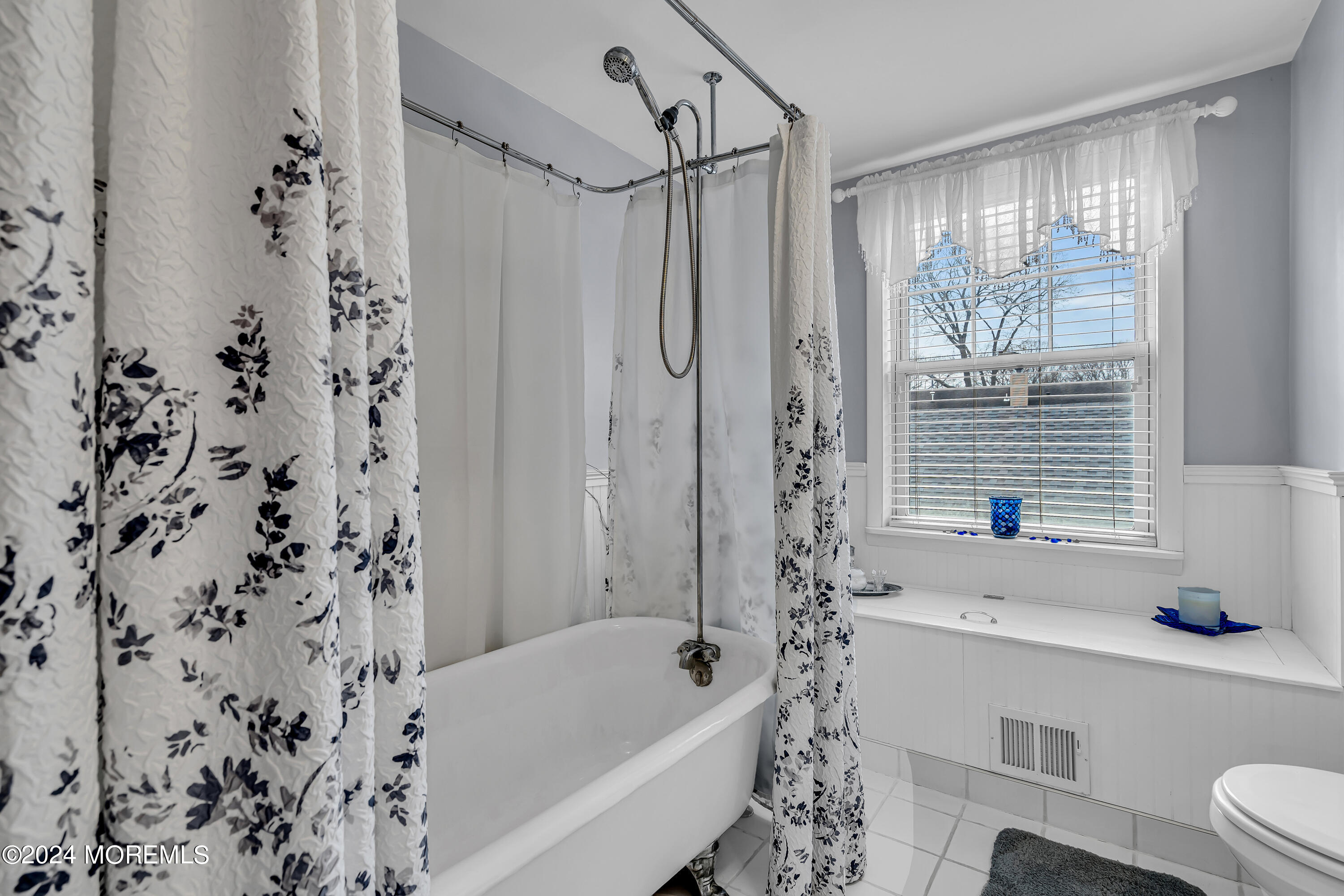 2412 Dunkle Road Point Pleasant, NJ 08742 - Photo 28 of 51 a bathroom with a bathtub a window and a shower