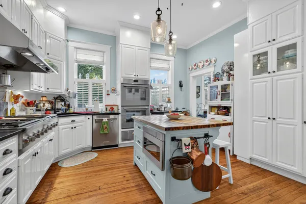 a kitchen with stainless steel appliances granite countertop a refrigerator and a sink